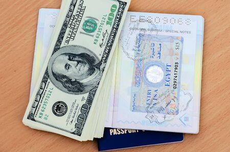 Stamp Egypt visa in passport, tourism and money dollars travel document