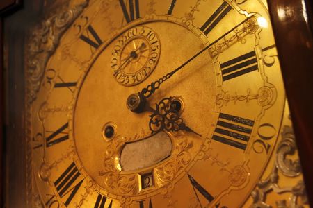 Ancient floor watch count modern time carved arrows showing on a gold dial transitoriness of life