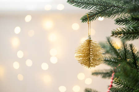 Christmas bauble on Christmas tree with lights bokeh backgroundの写真素材