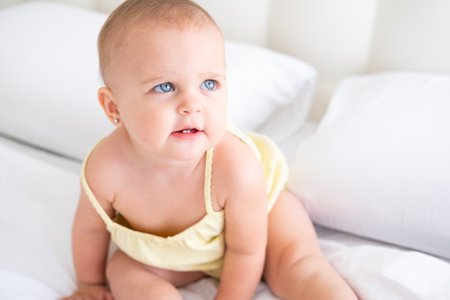 portrait of cute baby girl smiling with first milk teeth. Healthy newborn child