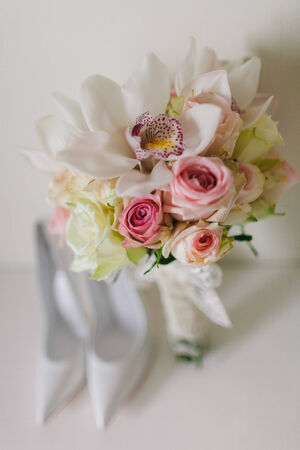 wedding bouquet  with orchids and roses and weddind brideの写真素材