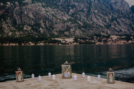 romantic candles lit on the coast of the Bay with mountain viewの写真素材