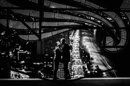 couple kissing on the roof in the night with night lights view in monochromeの写真素材