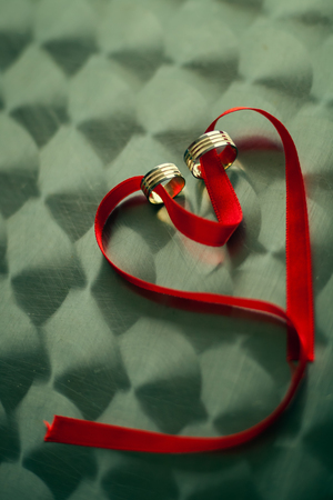 heart shape red band with engagement ringsの写真素材
