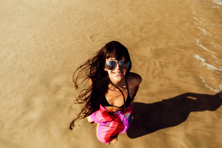happy girl in bikini on the beach in tropics top viewの写真素材