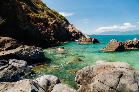 picturesque blue ocean lagoon beach with rocks nobody background in Vietnamの写真素材
