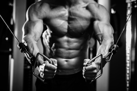 bodybuilder guy in gym pumping up hands close up. Black and whiteの写真素材