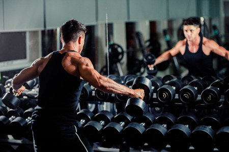 handsome athletic man workout in gym with weightsの写真素材