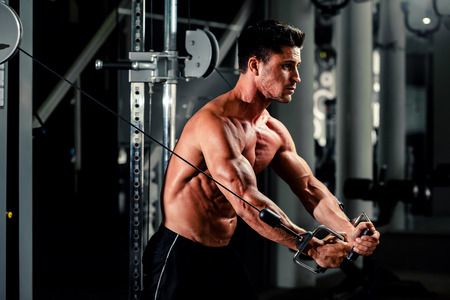 handsome bodybuilder works out  pushing up excercise in gymの写真素材