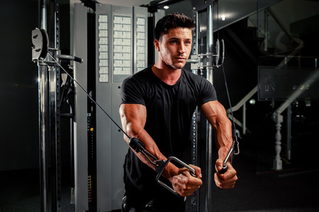 handsome bodybuilder works out  pushing up excercise in gymの写真素材