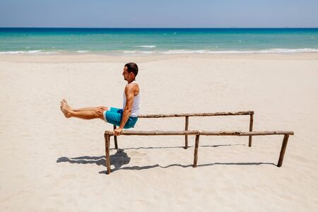 fitness handsome man work out on the beach with sea viewの写真素材