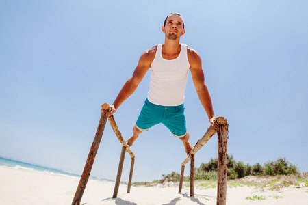 fitness handsome man work out on the beach with sea viewの写真素材