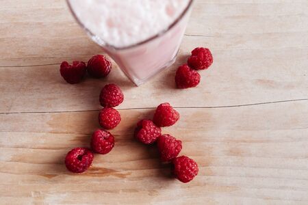 Raspberry smoothie fresh on summer wood table top viewの写真素材