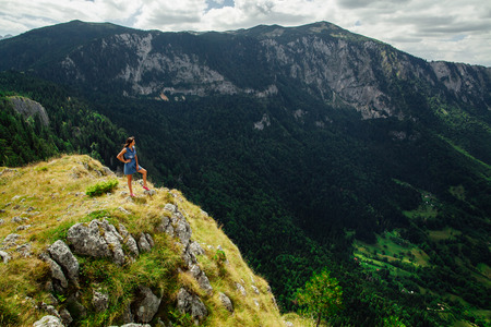 woman stand at the end of earth in fascinating landscape in Montenegroの写真素材