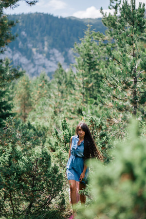 long hair woman travel in spruce forest with picturesque view in Montenegro, Durmitorの写真素材