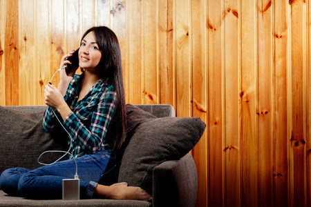 girl with powerbank charge telephone batteryの写真素材