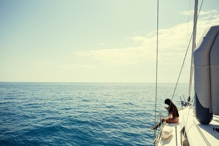 girl yachting with smartphone photograph cruise travel with picturesque seaview in Montenegroの写真素材