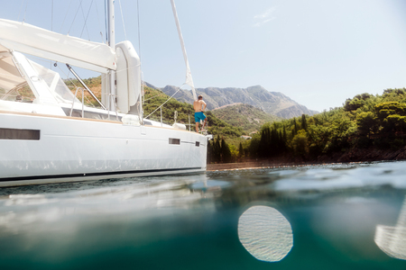 man yachting blue lagoon. View from waterの写真素材