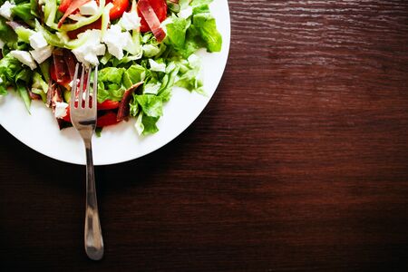 green salad on wood table top viewの写真素材