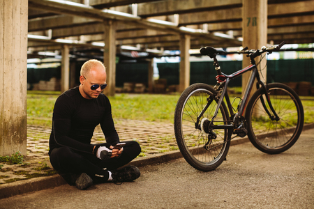 bicycle man searching in smartphone at parkingの写真素材