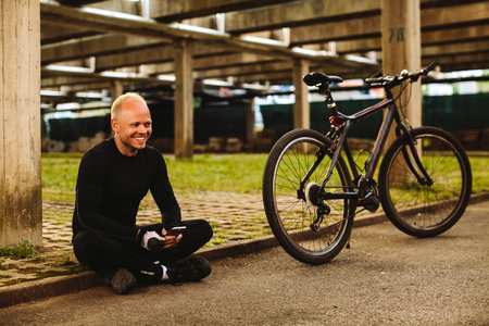 bicycle man searching in smartphone at parkingの写真素材