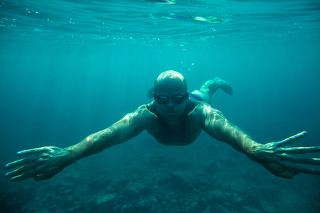 man swim underwater sea diveの写真素材