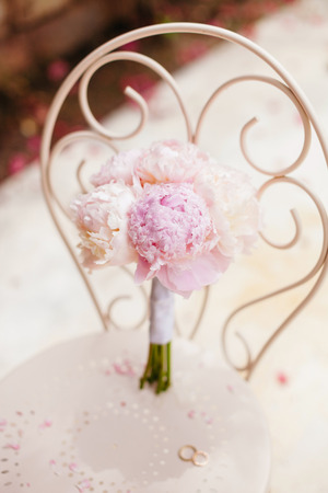 gentle wedding bouquet peonies with wedding rings in fine art styleの写真素材