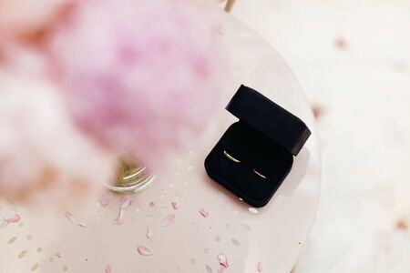 wedding rings with peonies background. top viewの写真素材