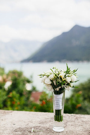 white flowers bouquet outdoors with mountains backgroundの写真素材