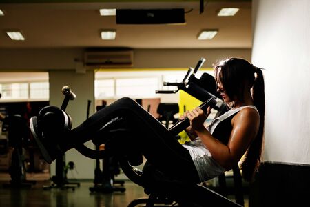 sexy girl training abs at gym workoutの写真素材