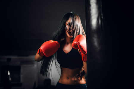 sexy fighter girl punching actively. motion long hairの写真素材