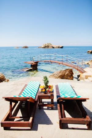 summer picnic on beach with tropical fruits and vine. Sea viewの写真素材