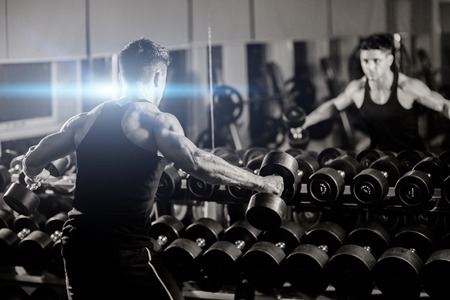 handsome athletic man workout in gym with weightsの写真素材