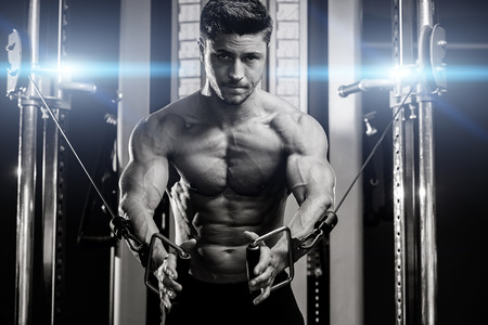 handsome bodybuilder works out  pushing up excercise in gymの写真素材