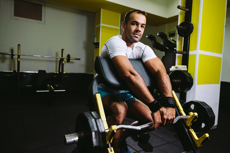 bodybuilder pumping up hands in gymの写真素材