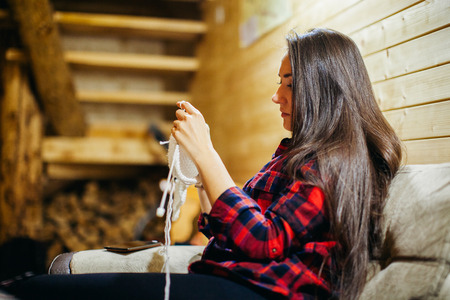 woman knit scarf in wood house. Long hair woman in chaleの写真素材