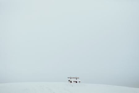 snow mountain with wooden bench. Winter landscapeの写真素材