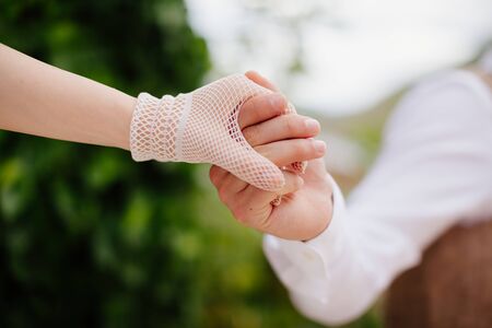 bride and groom holding hands together with bouquet background. Fine art styleの写真素材