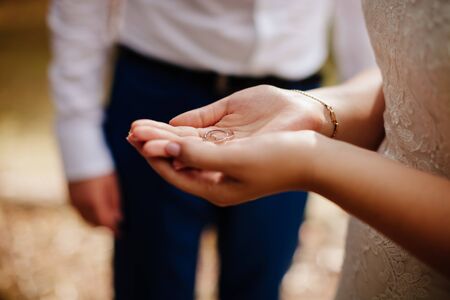wedding rings in bride's hands macroの写真素材