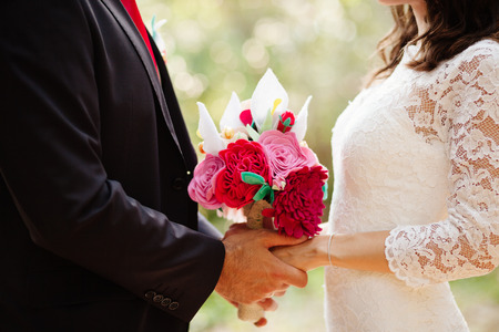 felt wedding bouquet handmade in newlywed hands close upの写真素材