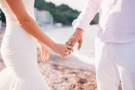 bride and groom holding hands together. Fine art styleの写真素材