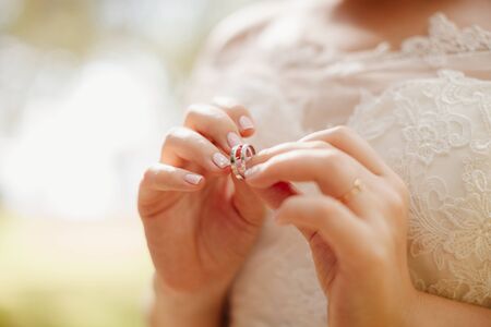 wedding rings in bride's hands macroの写真素材