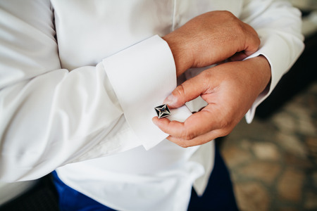groom wear cufflink close up shot with sea viewの写真素材