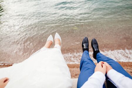 honeymoon couple embrace each other. Top view with sea backgroundの写真素材
