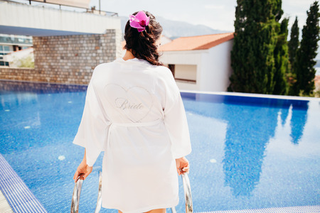 wedding bride in spa resort with swimming pool background.  Luxury destination weddingの写真素材