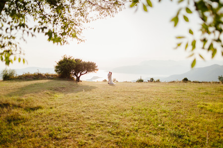 honeymoon wedding couple travel sea side. Back view. Mountains and sea background in Montenegroの写真素材