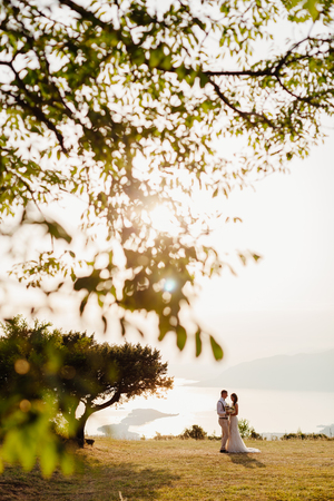 honeymoon wedding couple travel sea side. Back view. Mountains and sea background in Montenegroの写真素材