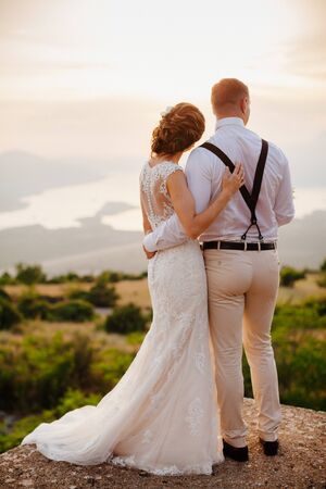 honeymoon couple embrace each other at sunset picturesque view. Fine art styleの写真素材