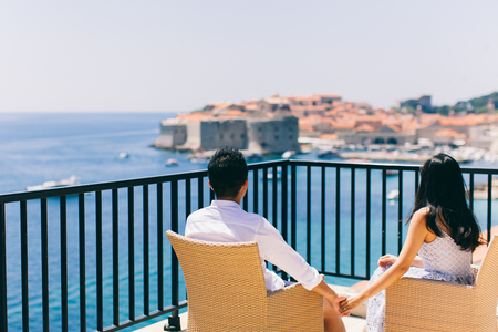 honeymoon couple  on vacation in Europe with sea view. Hands together back view. Dubrovnikの写真素材