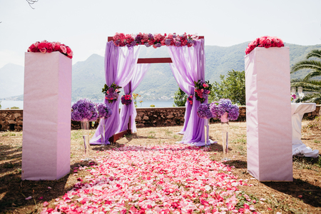 wedding isle and arch with weddings chairs and wedding flower decorationの写真素材